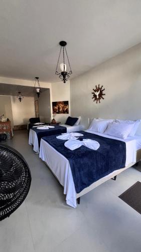 two beds in a hotel room with at Lofts do Pilar - pousada in Ouro Preto