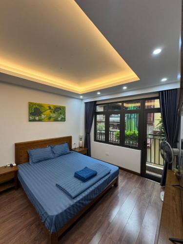a bedroom with a bed and a large window at 54 homestay Van Mieu in Hanoi