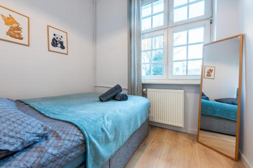 a bedroom with a bed and a mirror at Old Town Heaven Apartment in Gdańsk