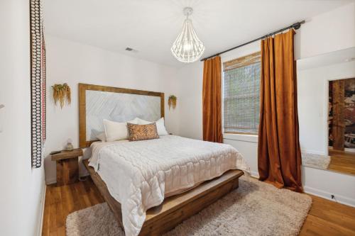 a bedroom with a bed and a window at Vibey Units in Duplex #A & #B in Madison