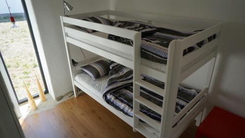 a white bunk bed in a room at Almbacka Logi in Skivarp