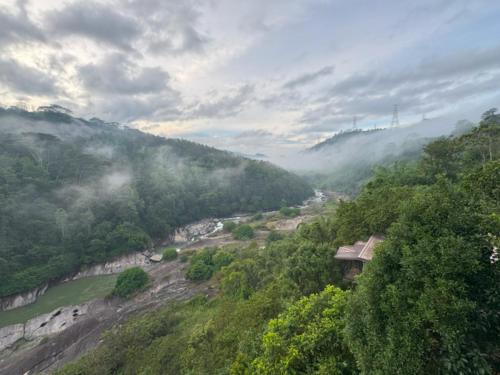 a view of a valley with a river and trees at Aqua Dunhinda Nature Retreat in Kandy