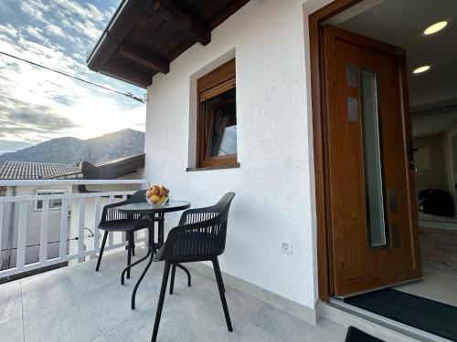 a balcony with two chairs and a table on a balcony at Apartments 16th Street in Mostar