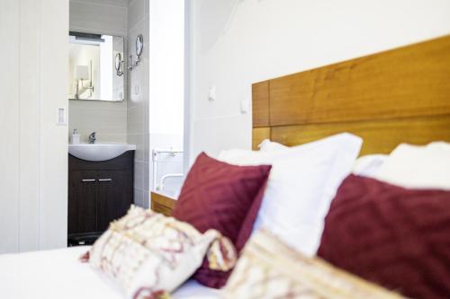a bedroom with a bed and a sink and a mirror at Aldeia das Adegas in São Roque do Pico