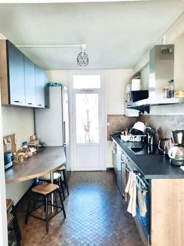 une cuisine avec une table et un réfrigérateur dans l'établissement Chambre PRIVÉE dans Appartement PARTAGÉ - Talence - Proche Tram C - WIFI - REF P1, à Talence