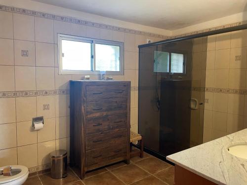 a bathroom with a shower and a sink and a toilet at CHACRA Los Ombues in Colonia Valdense