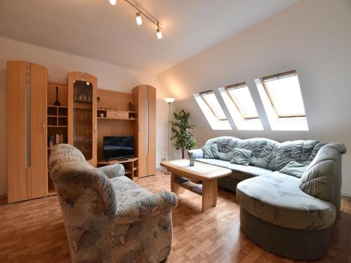 a living room with a couch and two chairs at Apartment near Castle Bothmer in Klütz