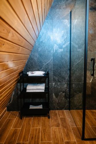 a small bathroom with a glass walled shower at Mosia Lui Mati in Tohani