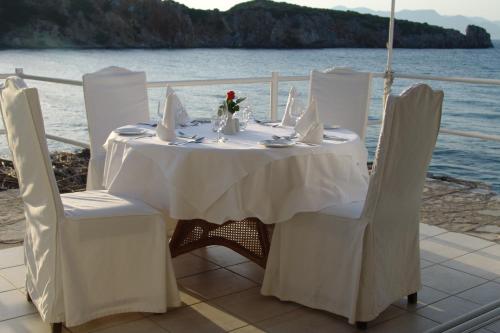 a table with white chairs and a white table and chairsktop at Istron Collection Villas in Istron