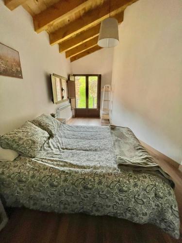 a bedroom with a large bed in a room at Casa del Horno in Viniegra de Arriba