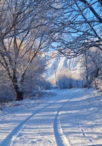 a snow covered road with tire tracks in the snow at GreenField Resort in Yeghegnadzor