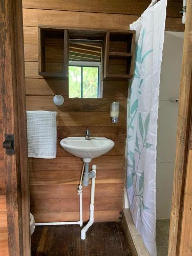 a bathroom with a sink in a tiny house at Majagua in Bahía Solano