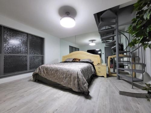 a bedroom with a bed and a spiral staircase at Urban Treehouse in Dallas