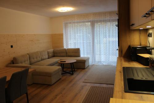 a living room with a couch and a table at Apartment Claudia in Bressanone