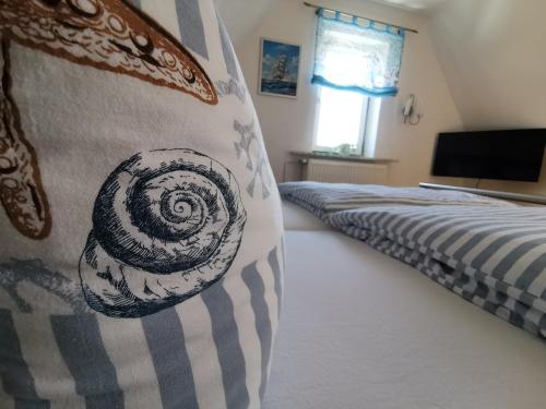 a bedroom with a bed and a vase on the wall at Gästehaus Arkona in Tönning