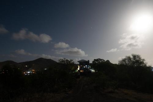 a view of the sun rising over a hill at GARNET--A gem at DEE'S PEARL in Carriacou
