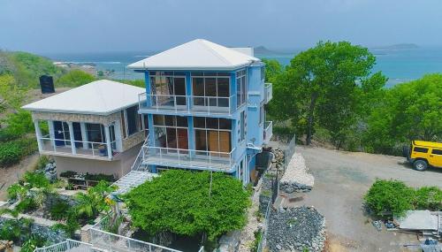 an aerial view of a blue house at GARNET--A gem at DEE'S PEARL in Carriacou