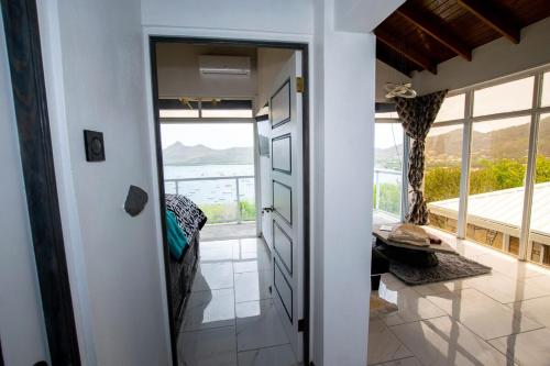 a room with a door leading to a room with a view at GARNET--A gem at DEE'S PEARL in Carriacou