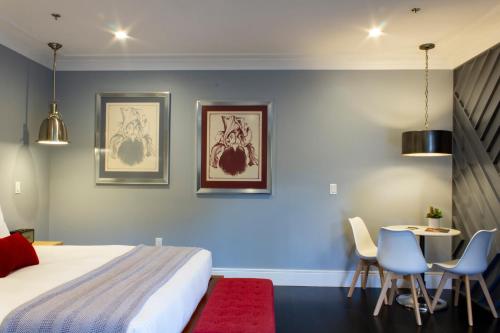 a bedroom with a bed and a table and chairs at Logan Inn in New Hope
