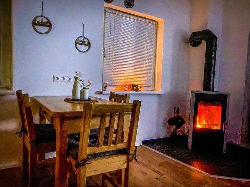 a dining room with a table and a wood stove at Ferienhaus an der Ybbs 