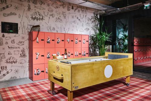 a room with a bath tub in front of a wall at Moxy Annecy in Annecy