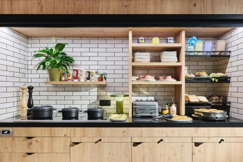 a kitchen with a counter with pots and pans at Moxy Annecy in Annecy