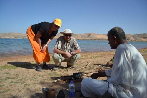 a group of three men standing on a beach at Hllol Hotel Abu Simbel in Abu Simbel