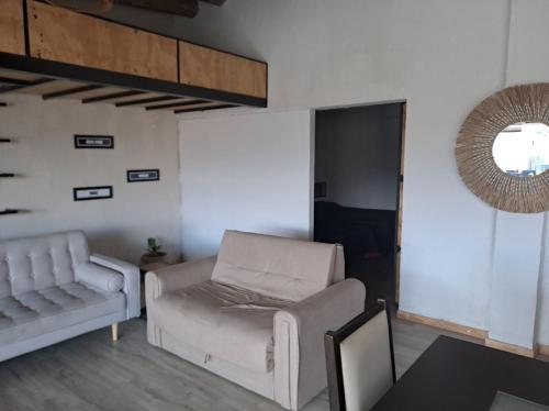 a living room with a couch and a chair at Sol montañes in La Carrodilla