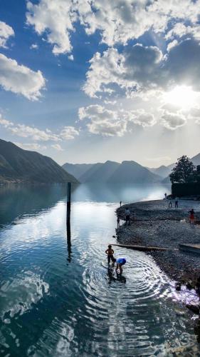 two people are playing in a body of water at Campidoglio vacation home in Lenno