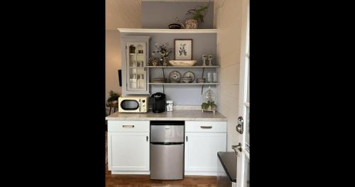 a kitchen with white cabinets and a stainless steel appliance at Historic Hutch House in Faribault