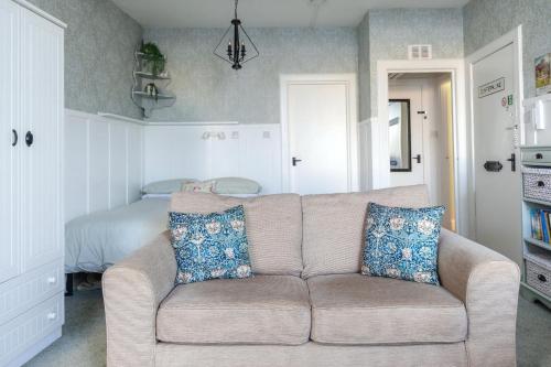 a living room with a couch and a bed at Carvetii - Meg's Studio - 1st Floor, Dunfermline City Centre in Dunfermline