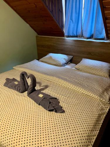 a robe laying on a bed in a bedroom at M1 Laczházy Hotel Coffee & More in Mocsa