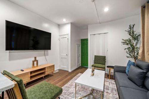 a living room with a couch and a tv on a wall at New 1-BD in Prime Philly Location with King Bed in Philadelphia