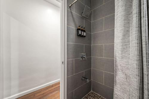 a bathroom with a shower with a shower curtain at New 1-BD in Prime Philly Location with King Bed in Philadelphia