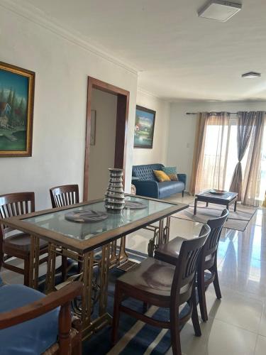 a living room with a table and chairs and a couch at Vista al Caribe in Los Mameyes