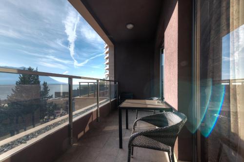 a balcony with a table and chairs and a view of the ocean at Sea View Apartments MonteBook in Becici