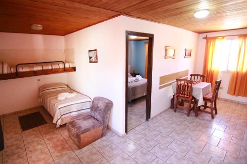 a bedroom with a bed and a table and chairs at Apartment Al Sur in Malargüe
