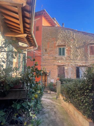 an old stone building with a bench in front of it at Virginia in Montecatini Alto