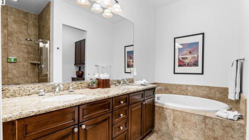 a bathroom with a tub and a sink at LV301 Awesome 3 Bedroom Legacy Villas Townhome in La Quinta