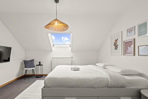 a white bedroom with a bed and a pendant light at Chambre privée au coeur de Bascharage in Bascharage