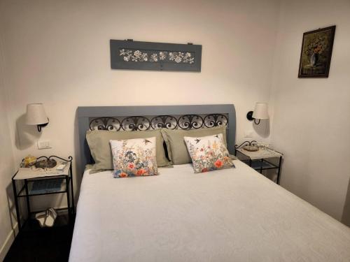 a bedroom with a bed with two side tables at Kira Apartment Bike Friendly in Massa Marittima