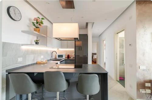 a kitchen with a large black island with chairs at 5 Stars Apart SEA VIEW in Genova