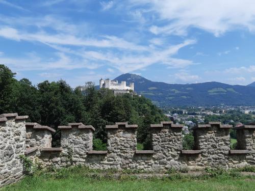 a stone wall with a castle in the background at Abis Ferienwohnung Salzkammergut in Strobl