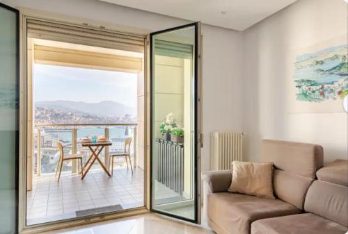 a living room with a couch and a balcony at 5 Stars Apart SEA VIEW in Genova