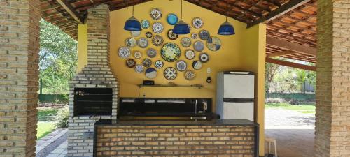 a wall with plates hanging on a wall at Flat Carvalhos de Aldeia km5 in Recife