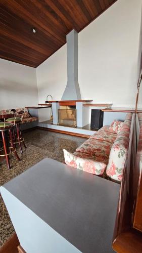 a bedroom with a bed and a table and a stove at Casa Saito in Campinas