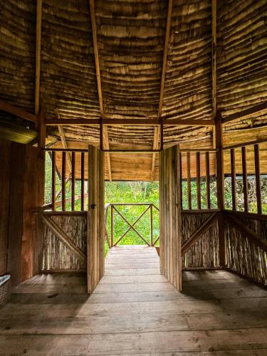 a wooden hallway in a barn with a wooden ceiling at PRIMITIVO LODGE & dive center in Bahía Solano