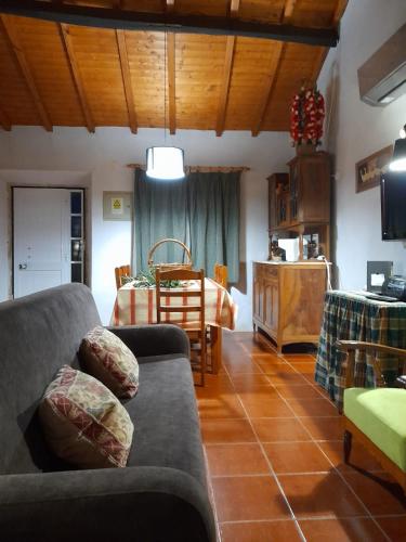 a living room with a couch and a bedroom at Casa dos Terranhos in Tomar