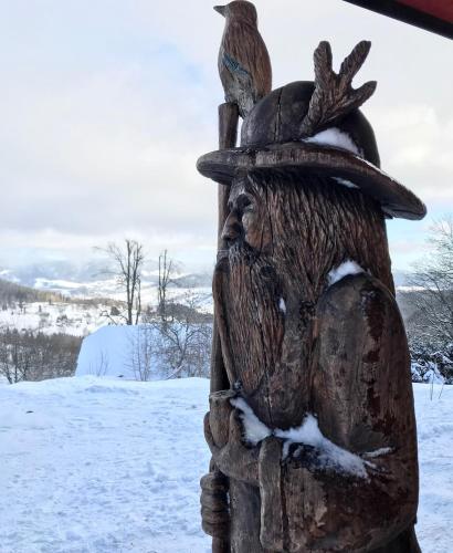 a statue of a person wearing a hat with a bird on it at Chata Hnyk in Zlatá Olešnice