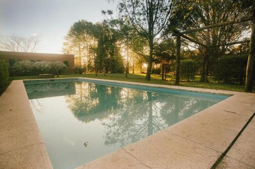 a swimming pool in the middle of a yard at CHACRA con VISTA AL CAMPO DE POLO in Pilar